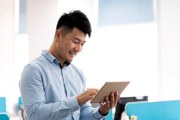 Man communicating with a business on a tablet